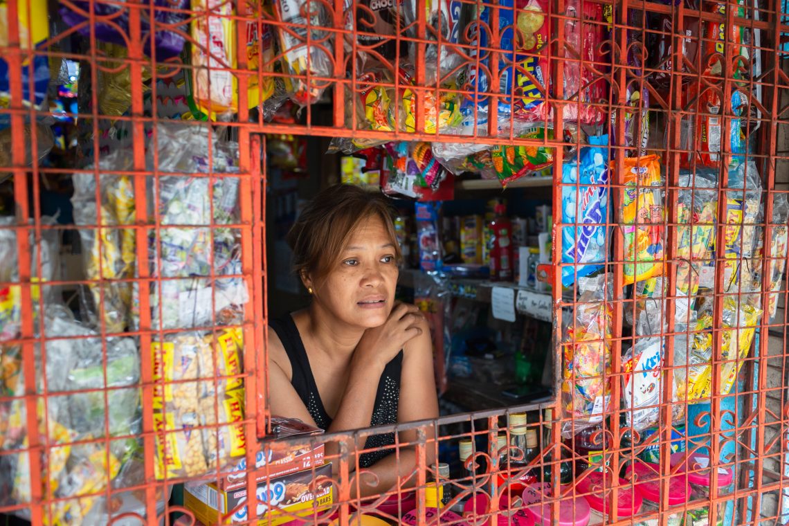 Woman at counter of her store