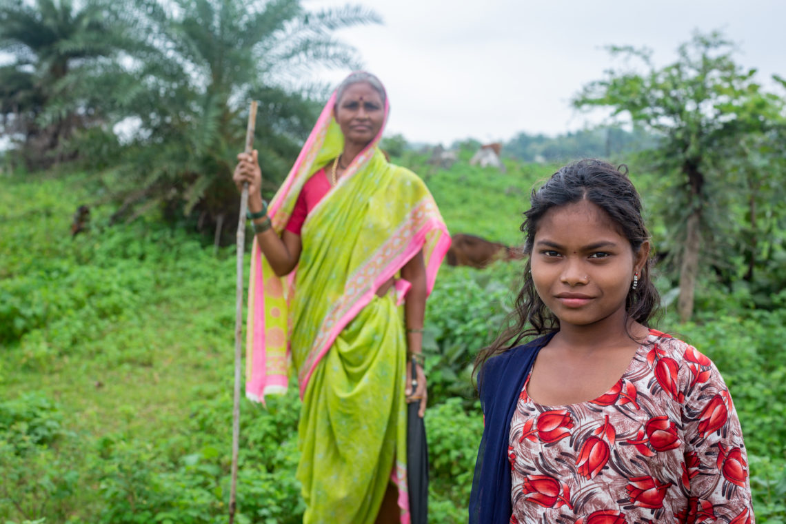 Indian woman and daughter strong and proud working in field