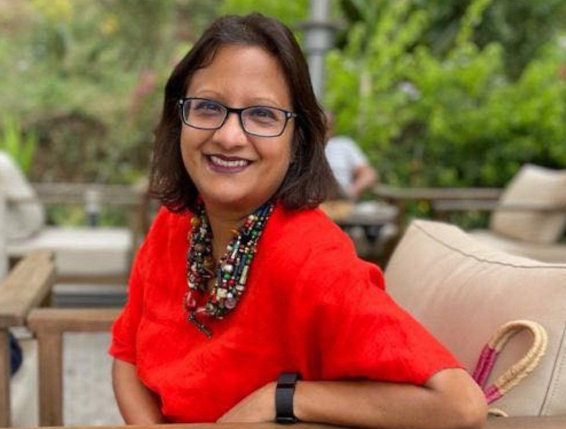 Grameen Foundation President and CEO sits outside