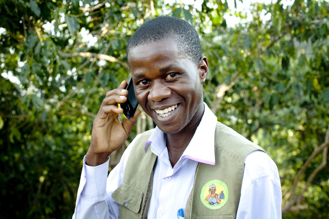 Community Agent on phone smiling