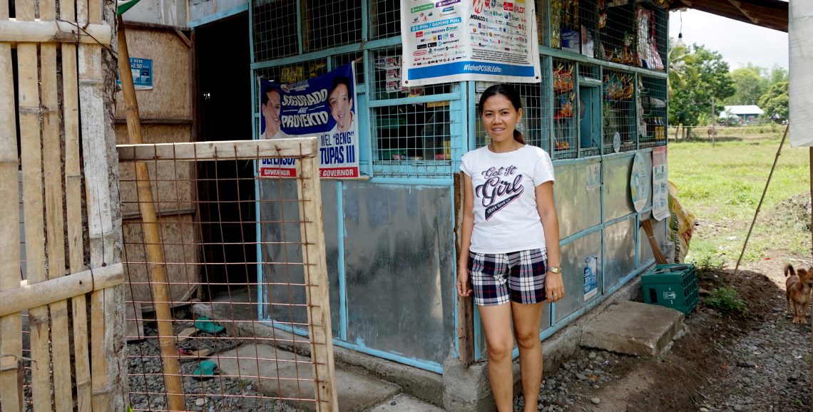 Grameen Community Agent outside rural sari sari shop