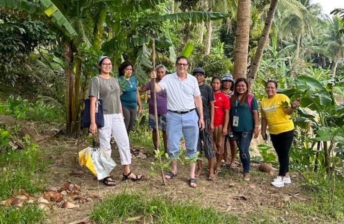 BWB Volunteer Ken Abbott (center) stands with a group of farmers in the Philippines