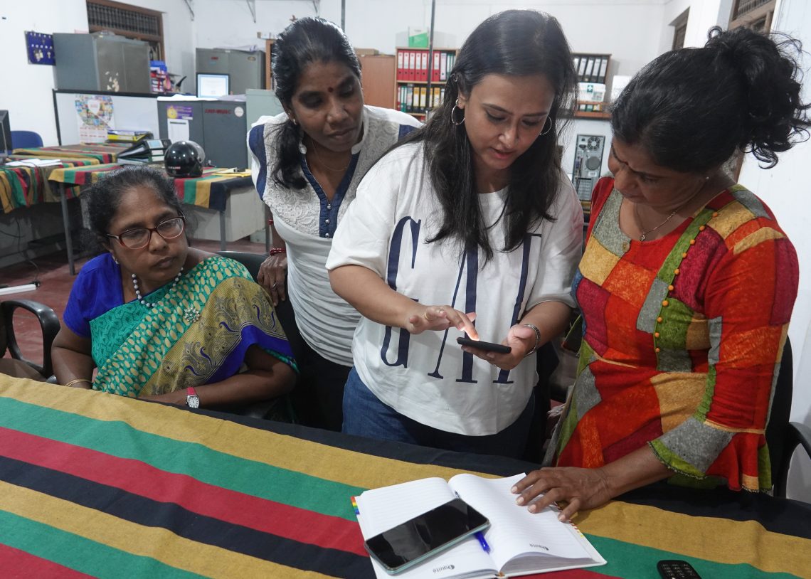 Women in Srilanka looking at Mobile Device