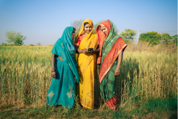 Three women looking at smart phone