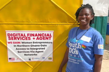 Patience stands in front of her Grameen Agent booth in northern Ghana