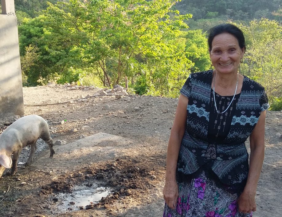 A pig farmer named Graciana, who lives in Latin America