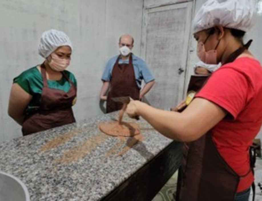 Joyce training her colleagues on the cacao production process.