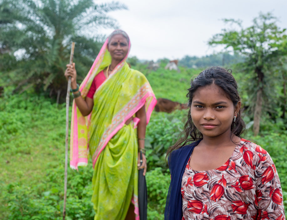 Indian woman and daughter in field