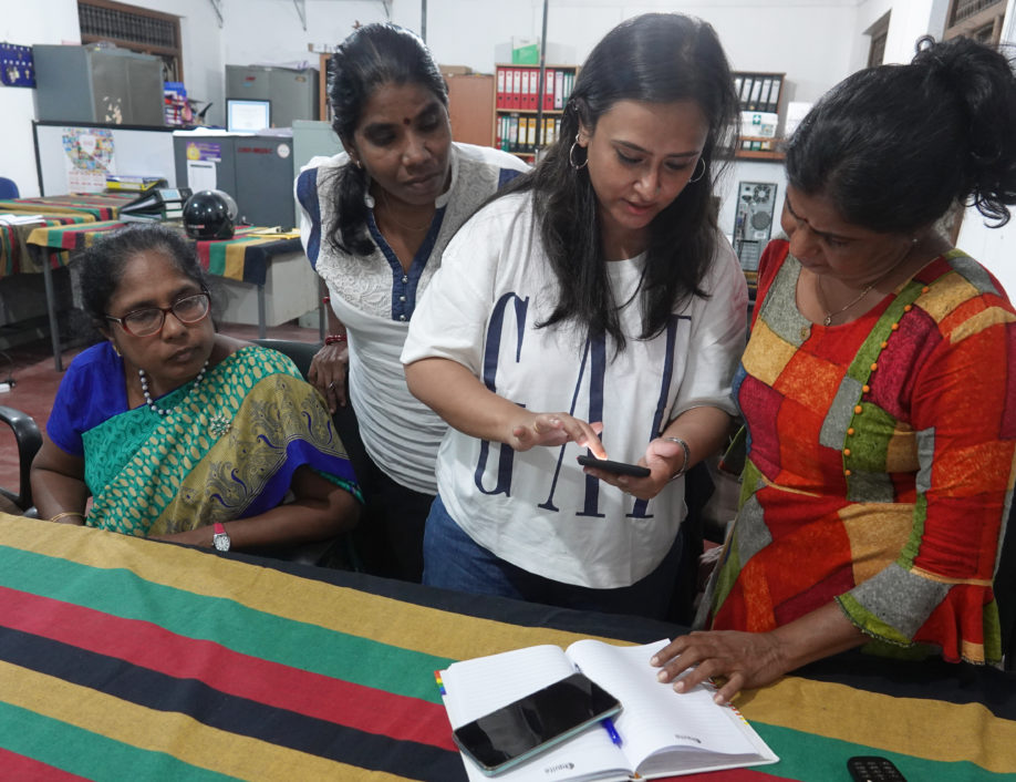 Women in Srilanka looking at Mobile Device